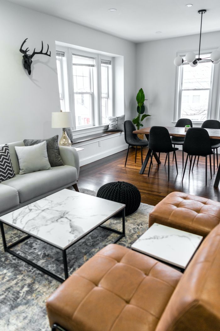 Crafting Captivating Headlines: Your awesome post title goes here Stylish living and dining area with elegant table, cozy chairs, and modern decor.